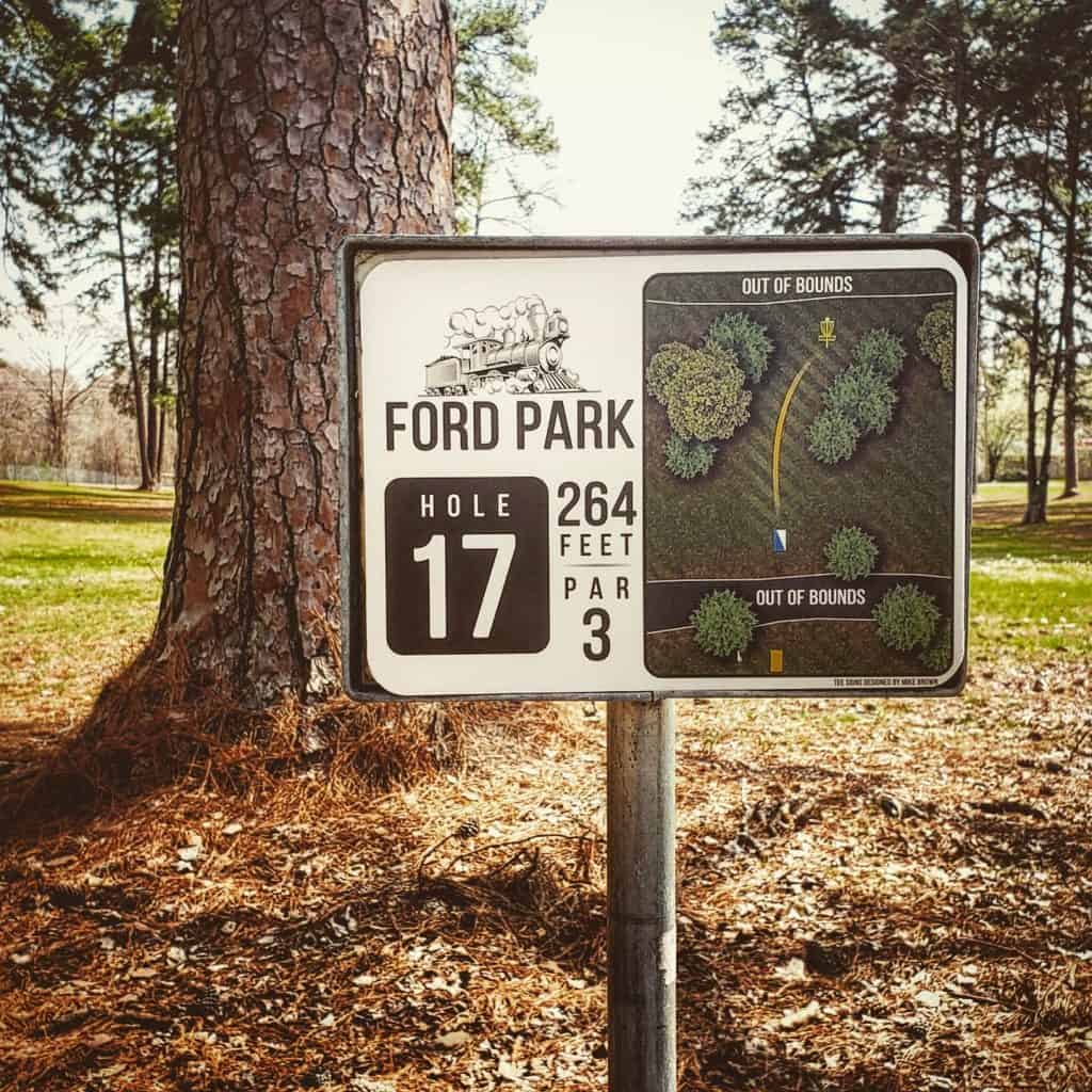 Custom disc golf tee sign at Ford Park showing hole layout and distance of 264 feet.