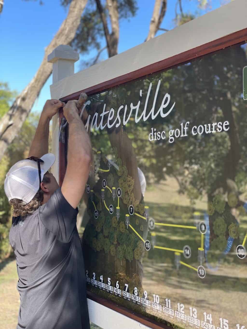 Installing a disc golf course sign at Gatesville disc golf course.