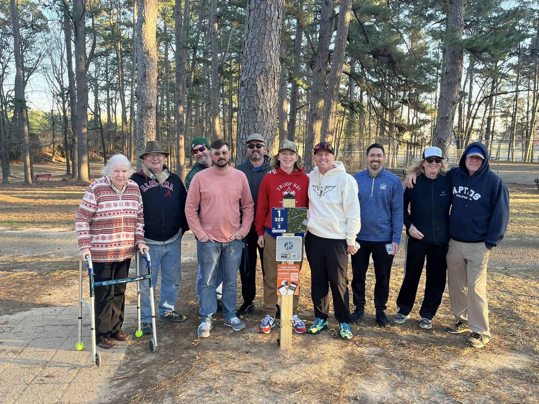 Custom disc golf tee sign in the ground at a course tee pad