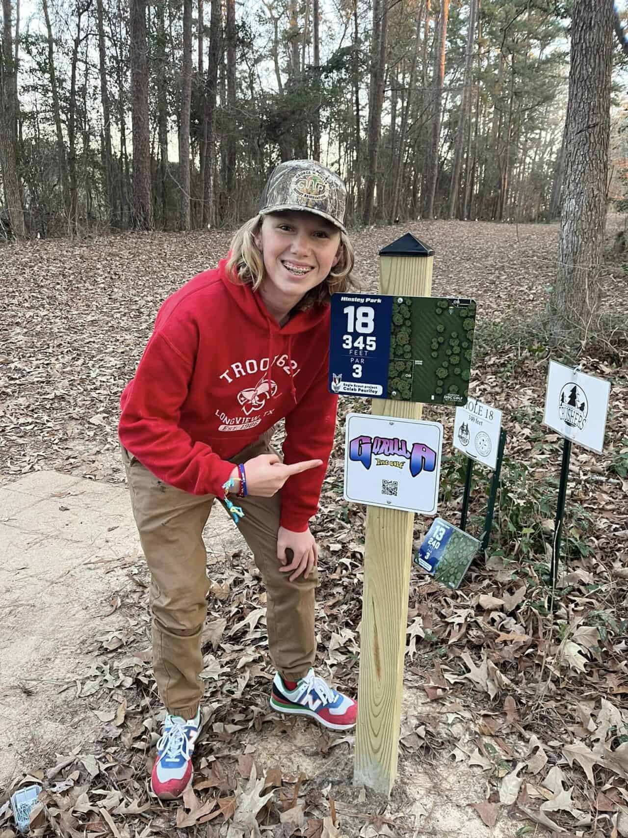 Disc golf course sign with hole number, distance, and par info.